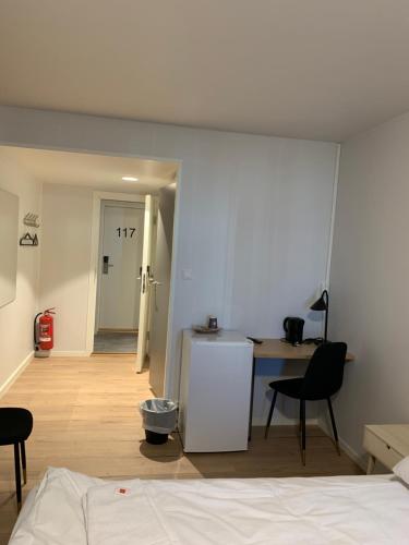 Postel nebo postele na pokoji v ubytování Husnes Sentrum Hotell