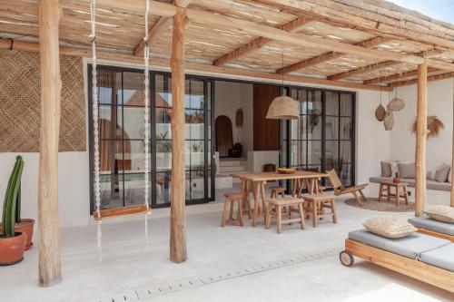 an open living room with a table and chairs at YUCCA villas in Canggu