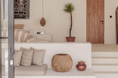 a living room with a couch and a plant at YUCCA villas in Canggu