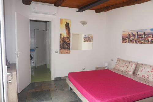 a bedroom with a pink bed in a room at Bergamum F.L. in Bergamo