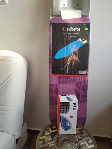 a box of colato on a table next to a printer at Vastu Dead Sea apartment in Arad