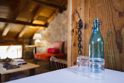 a bottle sitting on a table with two glasses at LA PITA in La Valle