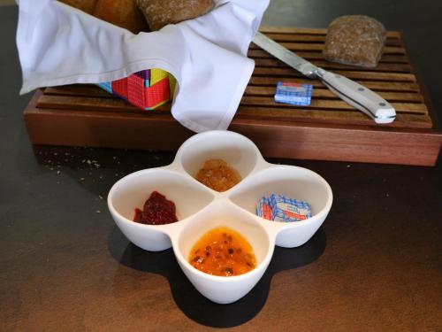 two bowls of food sitting on a table at THE BAHI VILLA - Adults Only B&B in Les Trois-Îlets