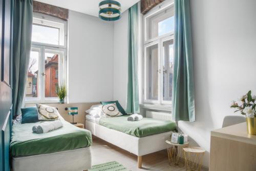 Ένα ή περισσότερα κρεβάτια σε δωμάτιο στο Kazimierz Residence Square