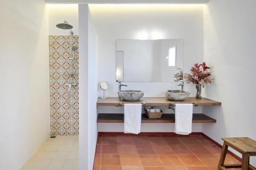 a bathroom with two sinks and a mirror at Son Camaro in Ciutadella