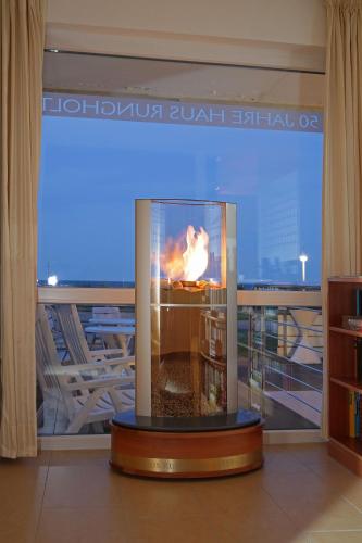 a fireplace in a room with a view of a city at Rungholt in Helgoland