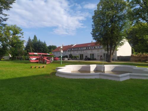 a park with a playground and a building at Hostel Browar Jedlinka in Jedlina-Zdrój