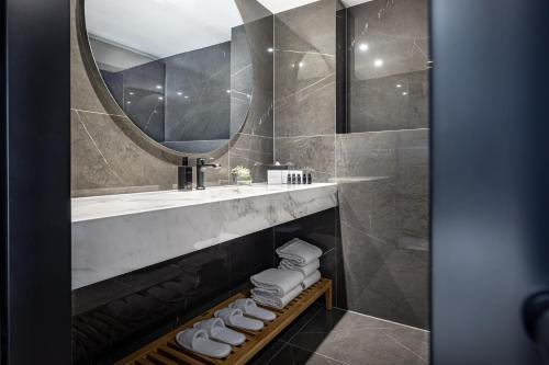 a bathroom with a sink and a mirror at Grand Hotel Adriatic in Opatija
