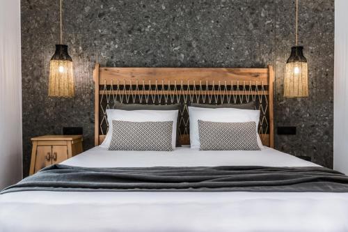 a bedroom with a large bed with two pillows at Naxian Secret in Naxos Chora