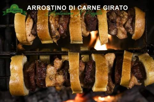 a bunch of kebabs being cooked in an oven at Agriturismo il Poggetto in Torre