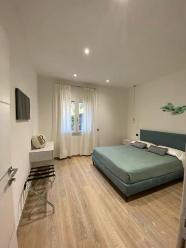 a bedroom with a bed and a television in it at 0.8 Guest House in Porto Ercole