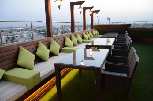 a row of tables and chairs on a balcony at Comfort Inn Tulip Heights in Bathinda