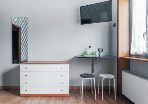 a bedroom with a dresser and two stools at B&B Papa Leone Countryrooms in Rome