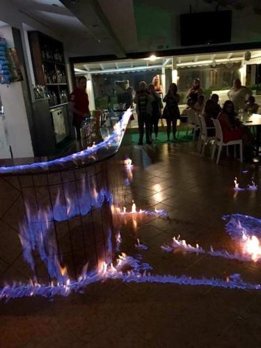 a dance floor with lights on the floor of a restaurant at Monika Hotel Sidari in Sidari
