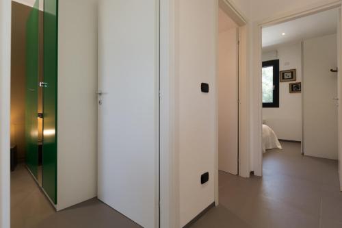 a hallway with a glass door and a bedroom at Villa Roberta by HDSalento in Specchiolla 