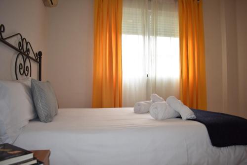 two stuffed animals sitting on top of a bed at Hotel El Ancla in Villanueva de la Cañada