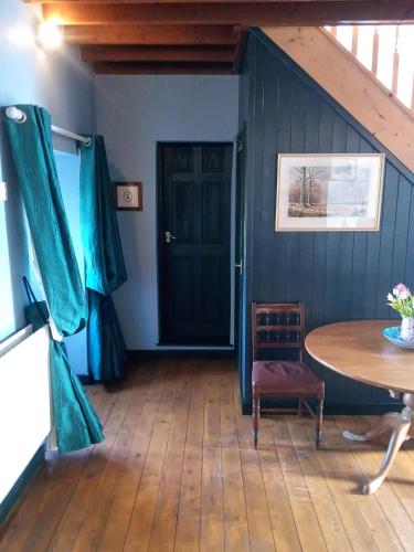a room with a table and a blue wall at The Threshing Barn in Harrogate