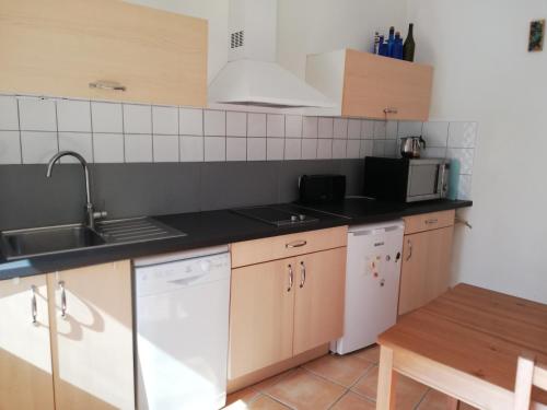 a kitchen with a sink and a stove top oven at Gite des Gorges de l'Ardèche in Chame