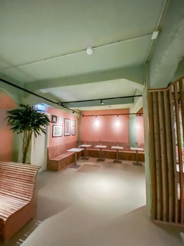 a waiting room with benches and a potted plant at Pink Flamingo Boutique Hostel in The Hague
