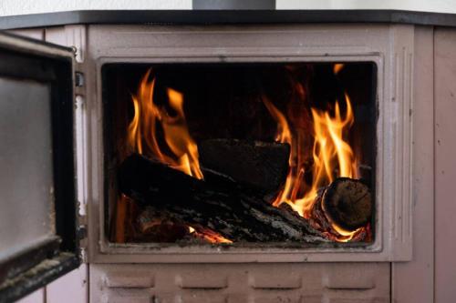 a fire in a brick oven with flames in it at JELA Countryside House in Kosjerić
