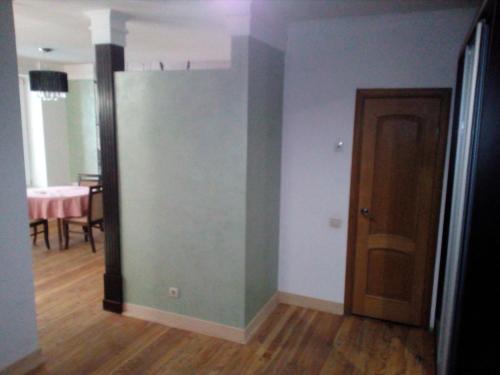 a room with a green wall and a dining room at Бруклінський міст.Студія в центрі. in Ivano-Frankivsʼk