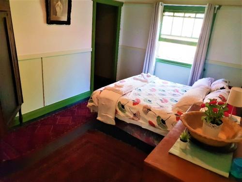 a small bedroom with a bed and a window at UNIQUE 1920's Historic Retreat! Pet Friendly! in Springwood