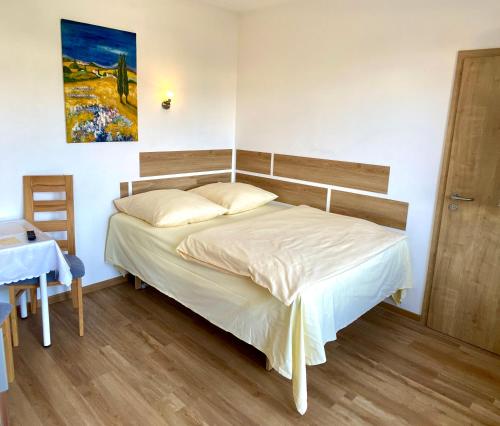 a bedroom with a bed with a wooden headboard at i-Motel in Obertshausen