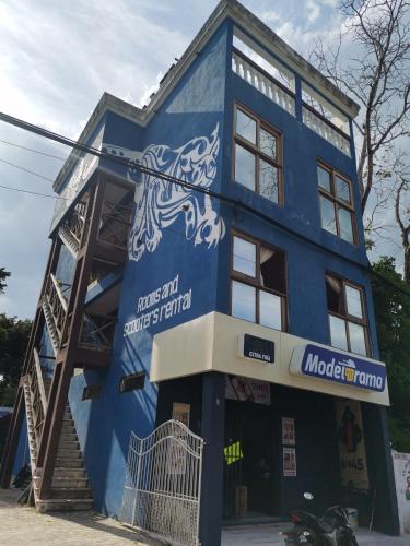 a blue building with a motorcycle parked in front of it at Aj Mun, Hotel Real Maya 3 in Valladolid