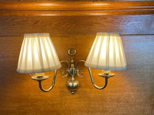 a pair of lights hanging on a wall at Ernespie House Hotel in Castle Douglas