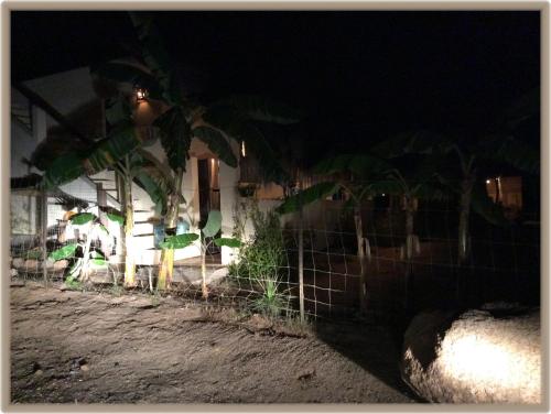 a fence in front of a house at night at Camp - Santos Cabanas in Todos Santos