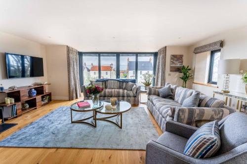 a living room with a couch and a table at The Breakers in Brancaster