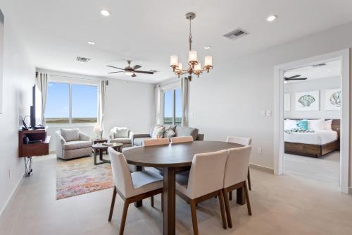a dining room and living room with a table and chairs at Sunset Caribe Belize in San Pedro