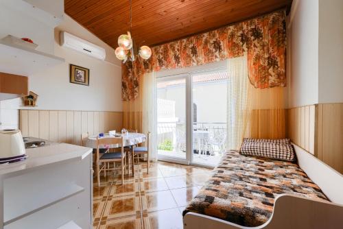 a kitchen and dining room with a bed in a room at Villa Fontana in Starigrad-Paklenica