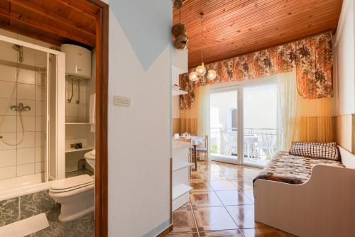 a bathroom with a toilet and a sink at Villa Fontana in Starigrad