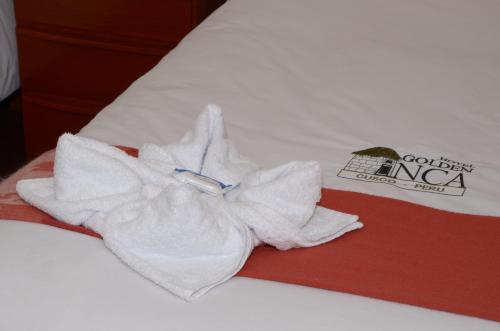 a pile of towels sitting on top of a bed at Golden Inca Hotel in Cusco