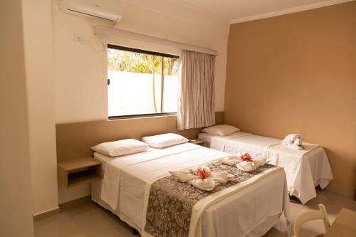 A bed or beds in a room at Pousada Ponta de Mangue