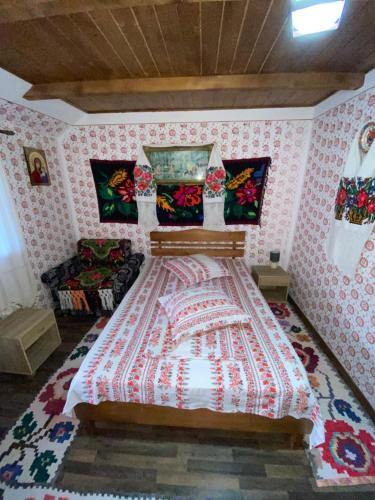 a bedroom with a large bed in a room at Floare de Maramures 1 in Vadu Izei