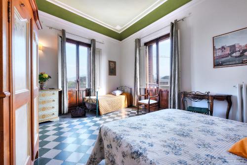 a bedroom with a bed with a checkered floor at Soggiorno Isabella De' Medici in Florence