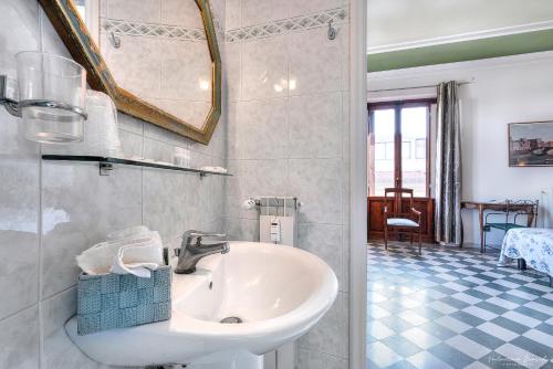 a bathroom with a sink and a mirror at Soggiorno Isabella De' Medici in Florence