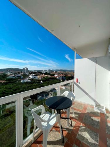 a balcony with two white chairs and a table at GoettenMar Platja d'Aro in Platja  d'Aro