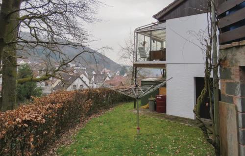a person sitting on a balcony of a house at Stunning Apartment In Hinterweidenthal in Hinterweidenthal