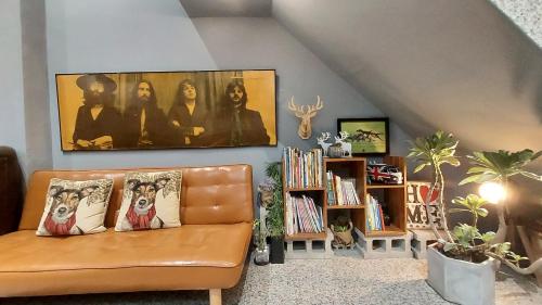 a living room with a couch with pillows on it at Youngnn Hostel in Lugang