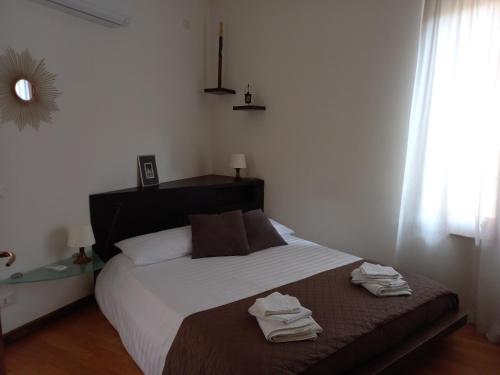 a bedroom with a bed with two towels on it at Home Scalzi 18 in Verona