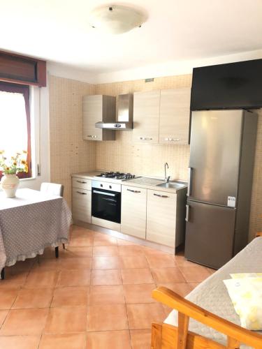 a kitchen with a stainless steel refrigerator and a table at Bed & Breakfast Il Sentiero in Agerola