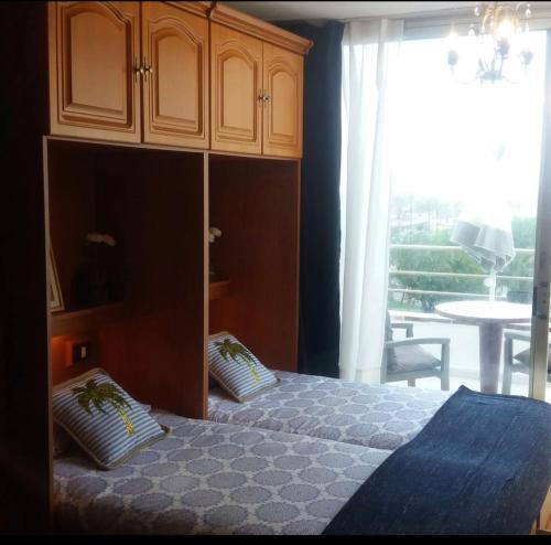 a bedroom with a bed and a cabinet with two pillows at Charming Holidays in Martiánez Beach in Puerto de la Cruz