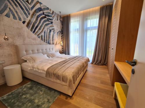 a bedroom with a bed with a zebra mural on the wall at Suiten-Aparthotel AENEA in Reifnitz