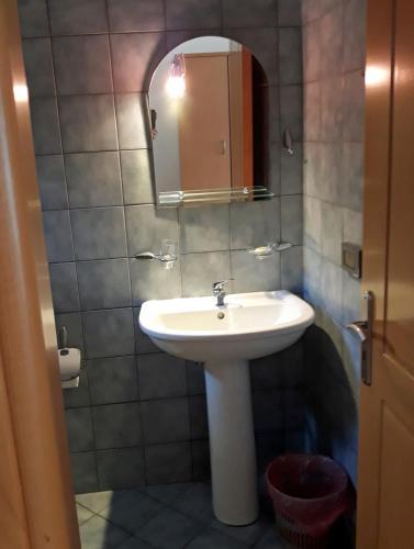 a bathroom with a sink and a mirror at Plataria Palace in Plataria