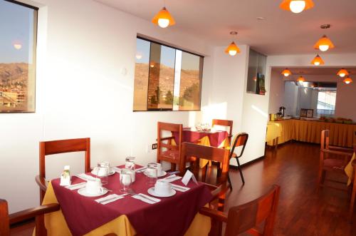 a dining room with a table with cups and saucers at Golden Inca Hotel in Cusco