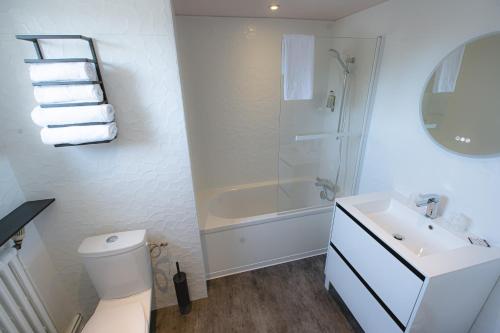a bathroom with a shower and a toilet and a sink at Hôtel Central in Poitiers