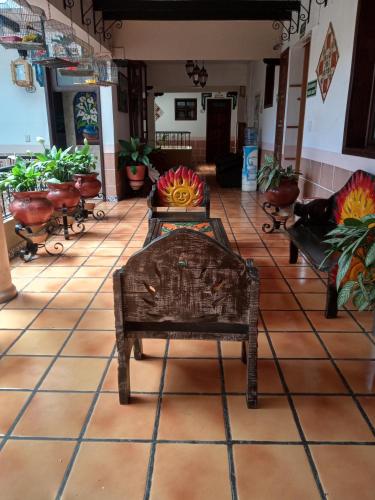 a room with tables and chairs in a store at Hotel Regis in Uruapan del Progreso